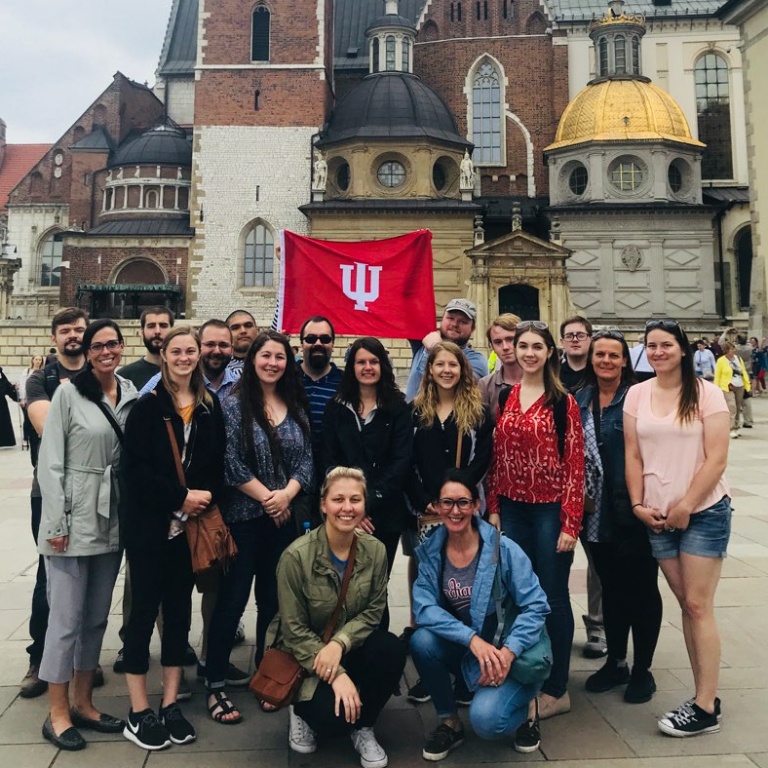 A group of students holding the IU banner.