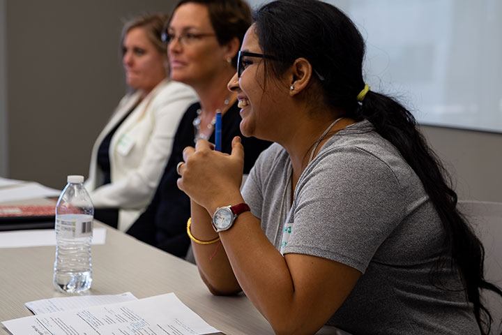Students talking at a table.