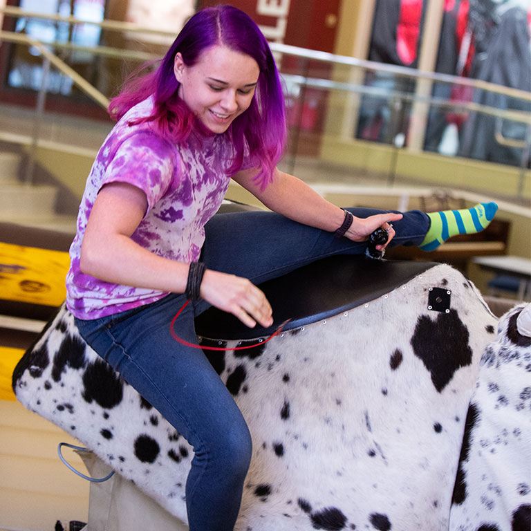 A female student on the mechanical bull.