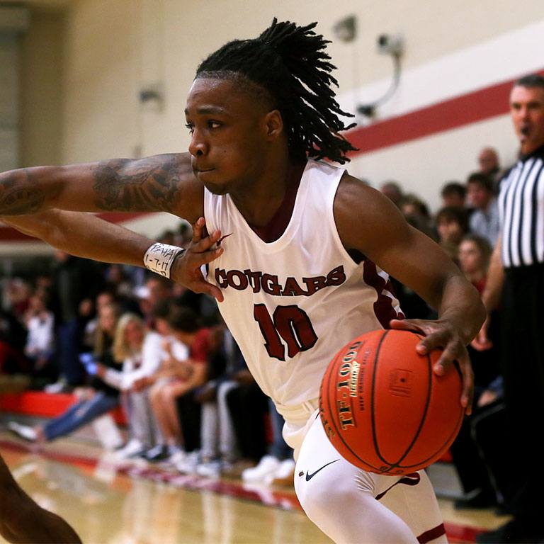 A student playing basketball.