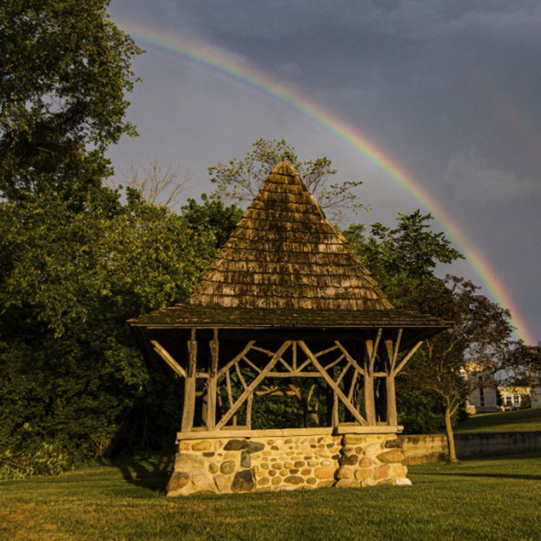 The well house with a rainbow.