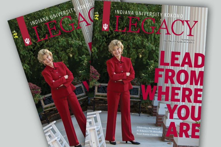 Sue Sciame Giesecke in a red suit standing with her arms folded.