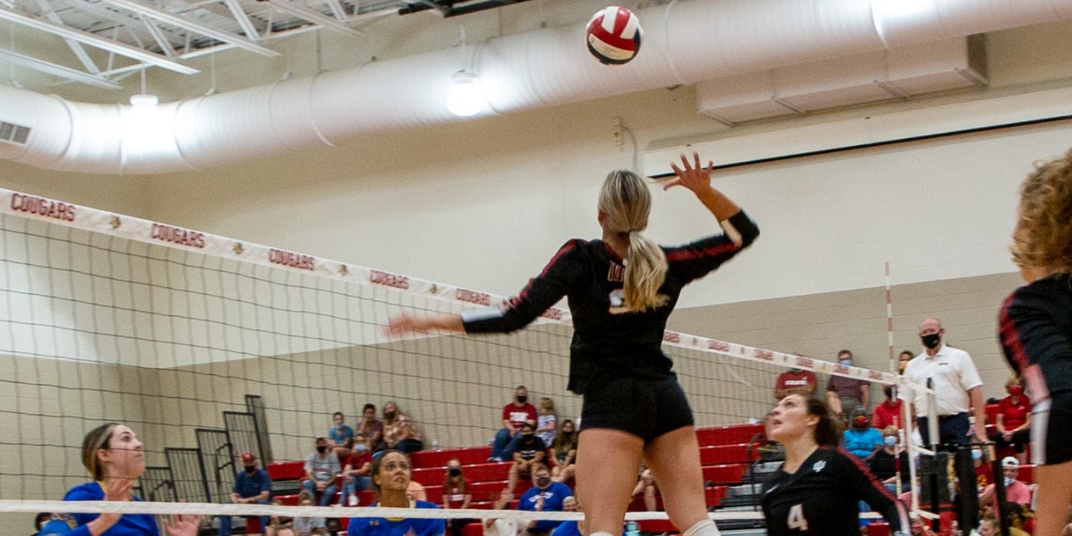 student athlete hitting volleyball in the air.