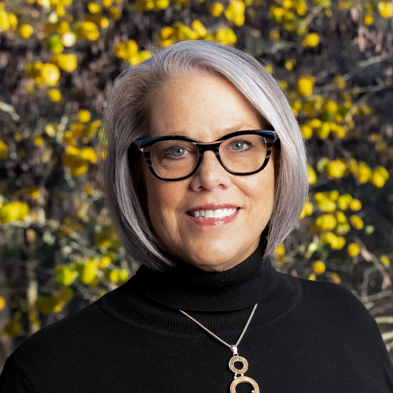 an image of Sarah Sarber wearing a red and black jacket