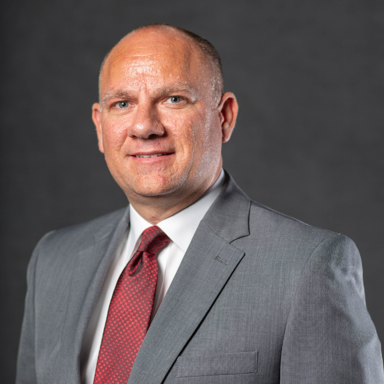 an image of Jared Hayman wearing a grey suit