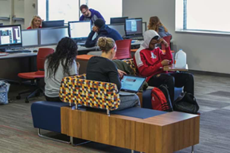 Students sitting in the library studying.